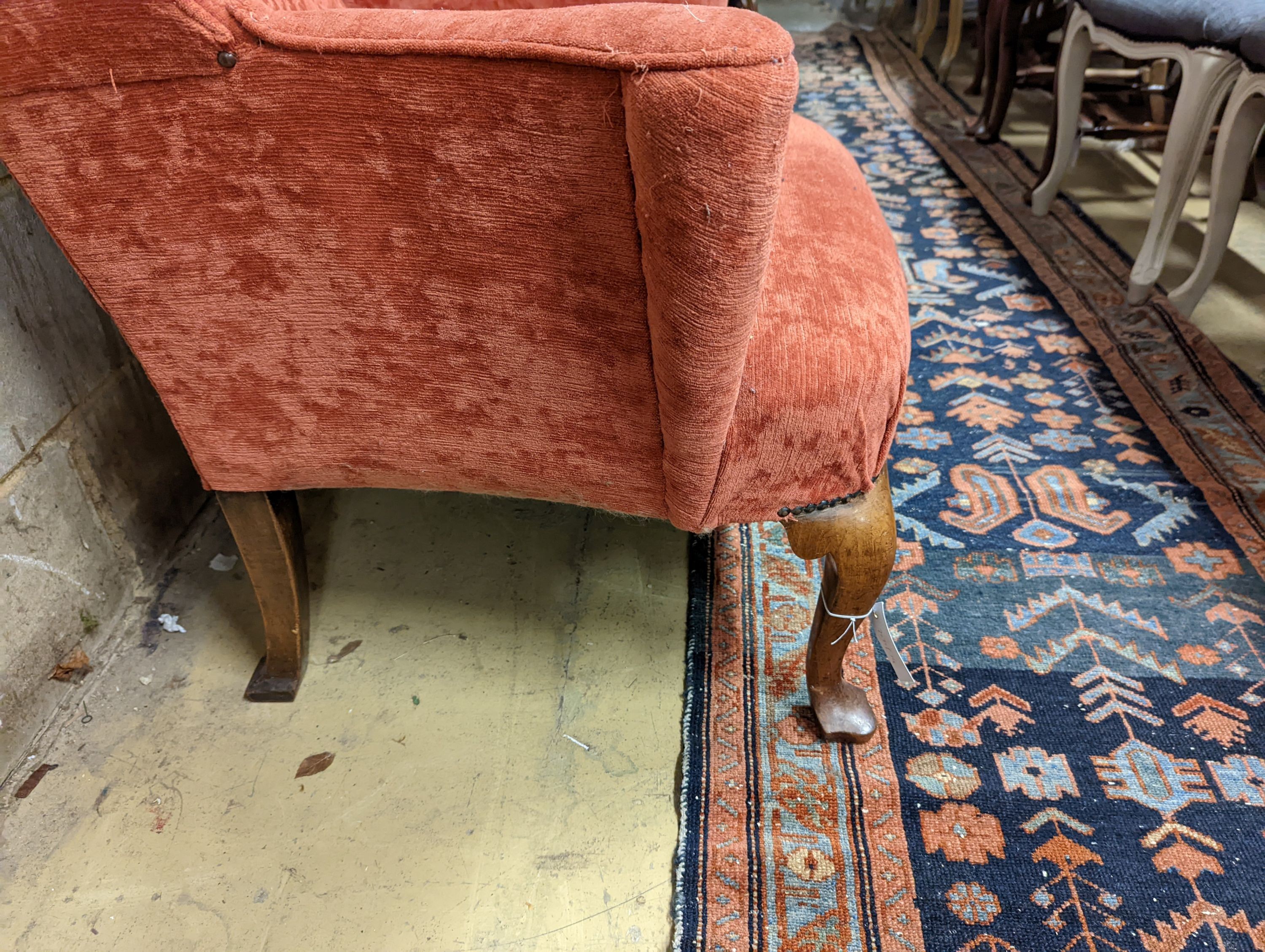 A Queen Anne style upholstered wingback armchair, width 78cm, depth 77cm, height 102cm
